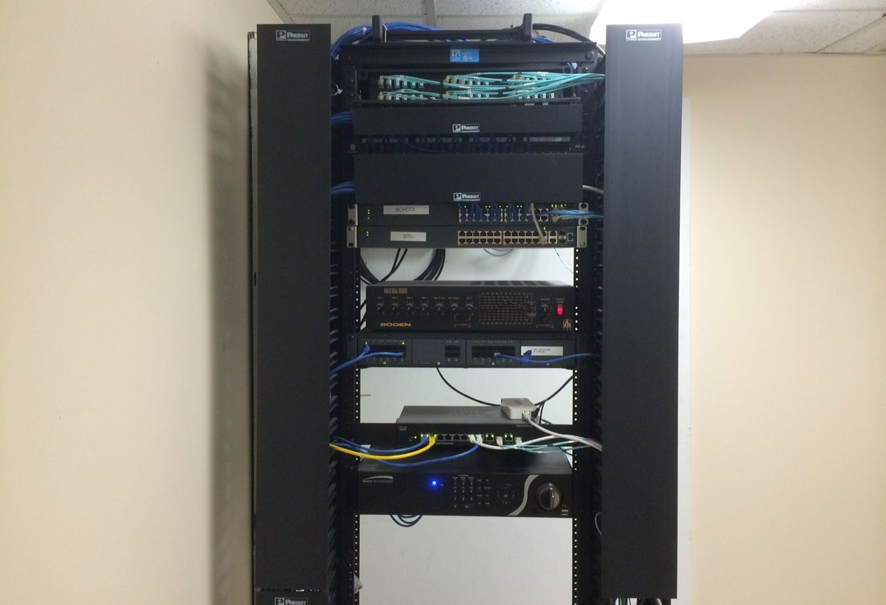 A server rack with a lot of wires coming out of it