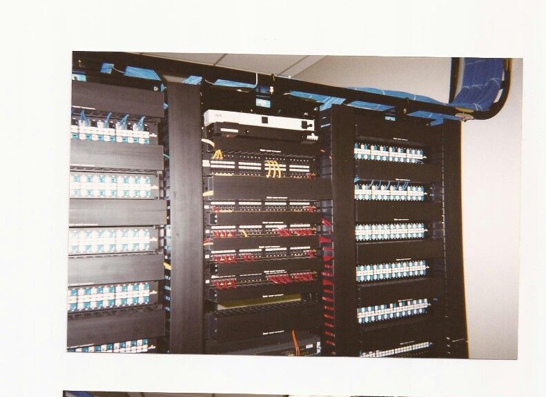 A picture of a server rack with lots of wires coming out of it