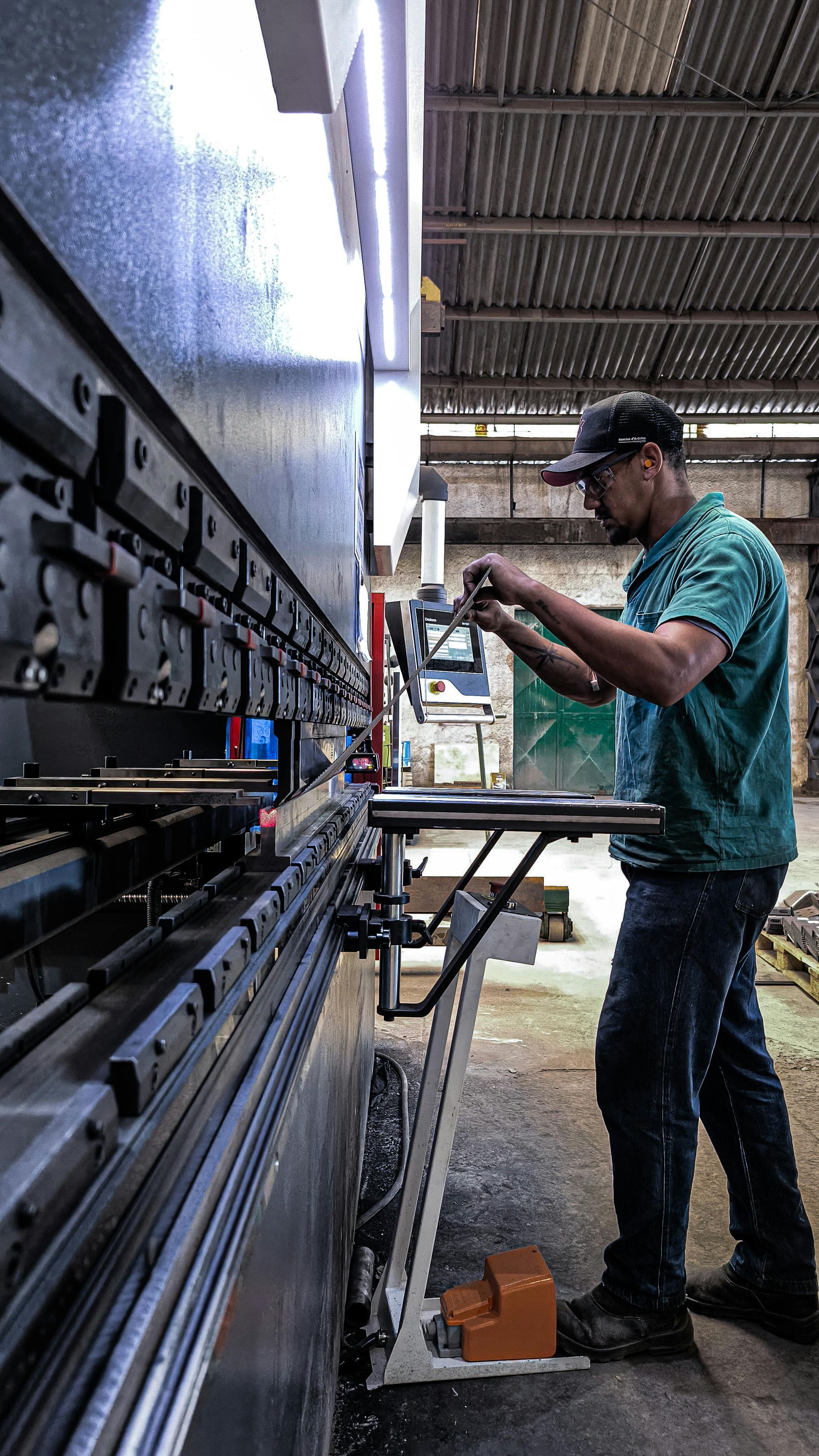 A man is working on a machine in a factory.