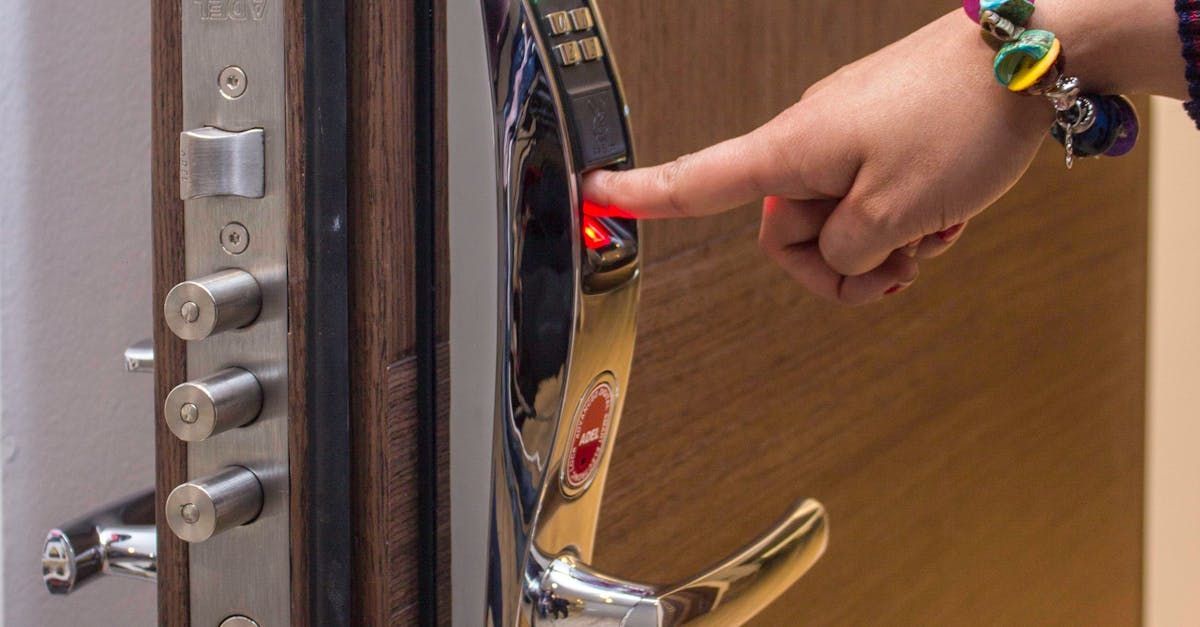 A person is pressing a button on a door with their finger.