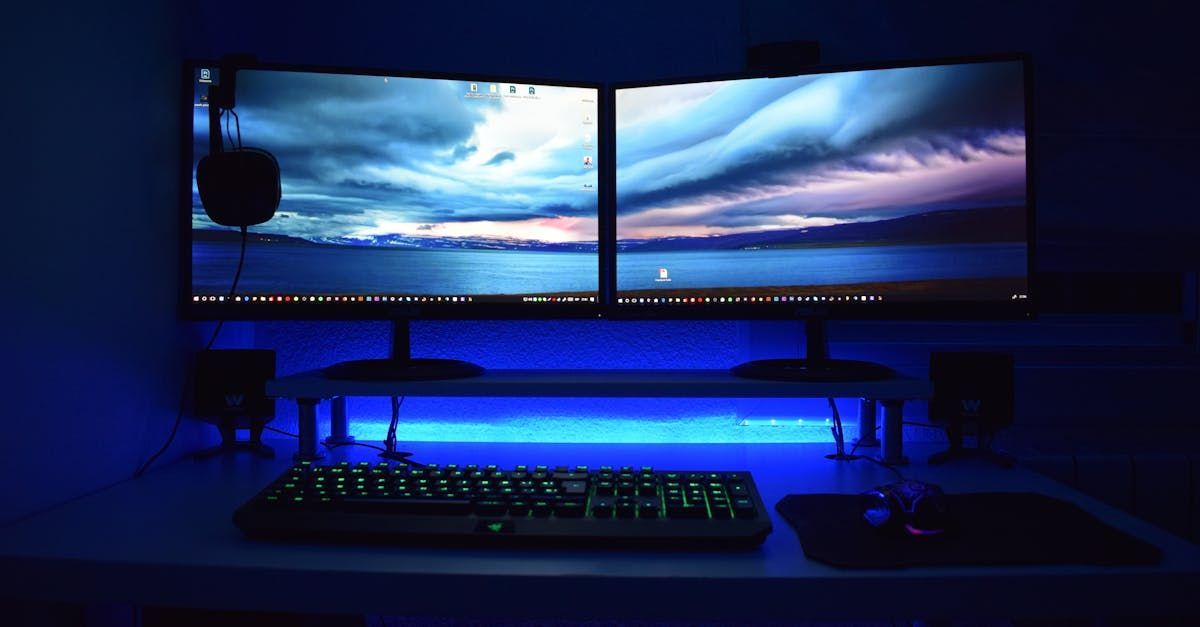 A computer desk with two monitors , a keyboard , and a mouse.