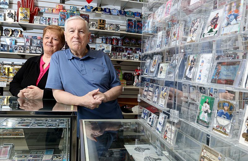 A man and a woman are standing in a store.