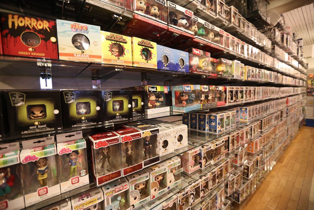 Rows of Funko Pop figures in boxes on shelves in a store.