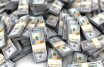 Stacks of hundred-dollar bills, bundled and piled in a chaotic heap.