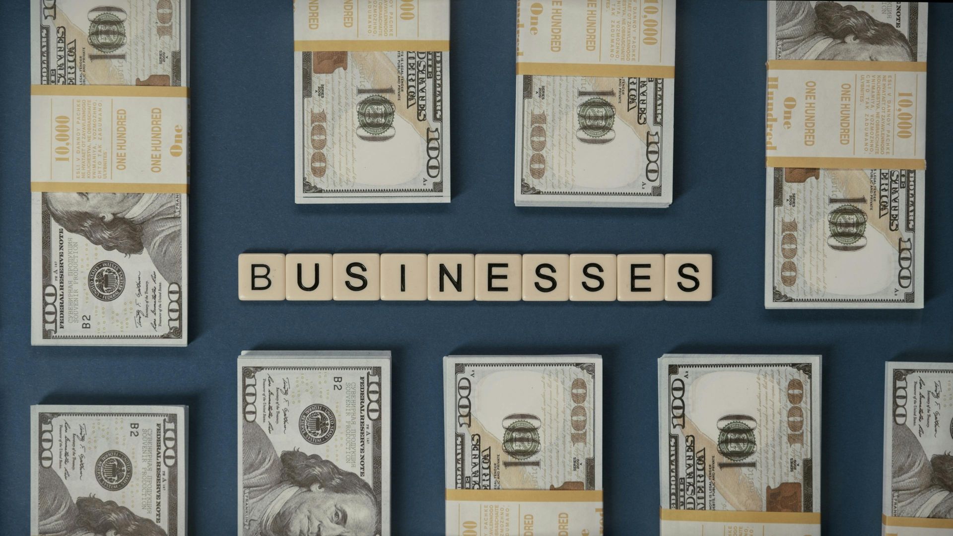 Bundles of $100 bills surround the word