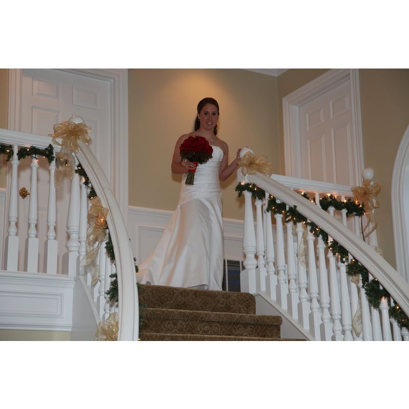 A woman in a wedding dress is standing on a set of stairs