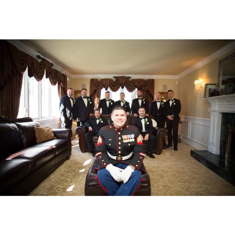 A group of men are posing for a picture in a living room