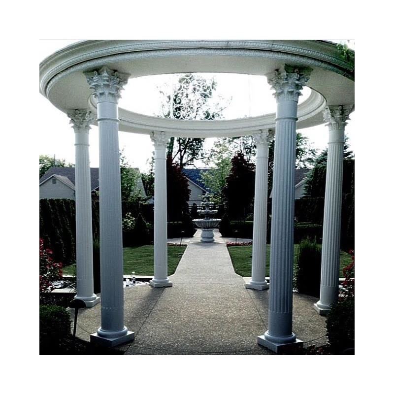 A white gazebo with columns in a garden