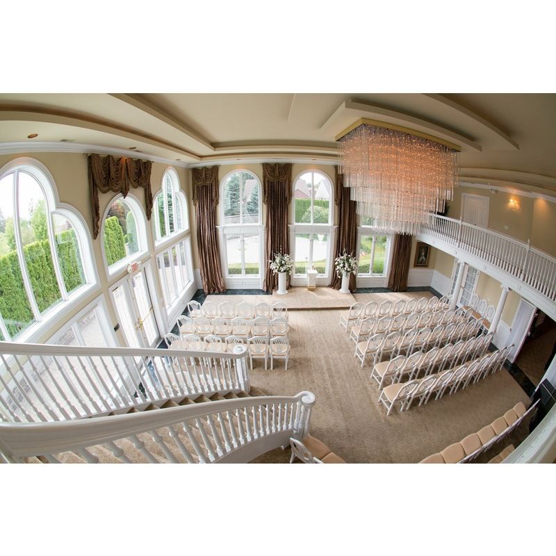 An aerial view of a large room with rows of chairs and a chandelier.