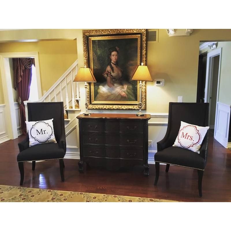 Two chairs with pillows that say mr. and mrs.