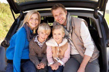 Happy Family at the Back of a Car — Insurance Services in Palm City, FL
