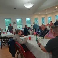 A group of people are sitting at tables in a room.