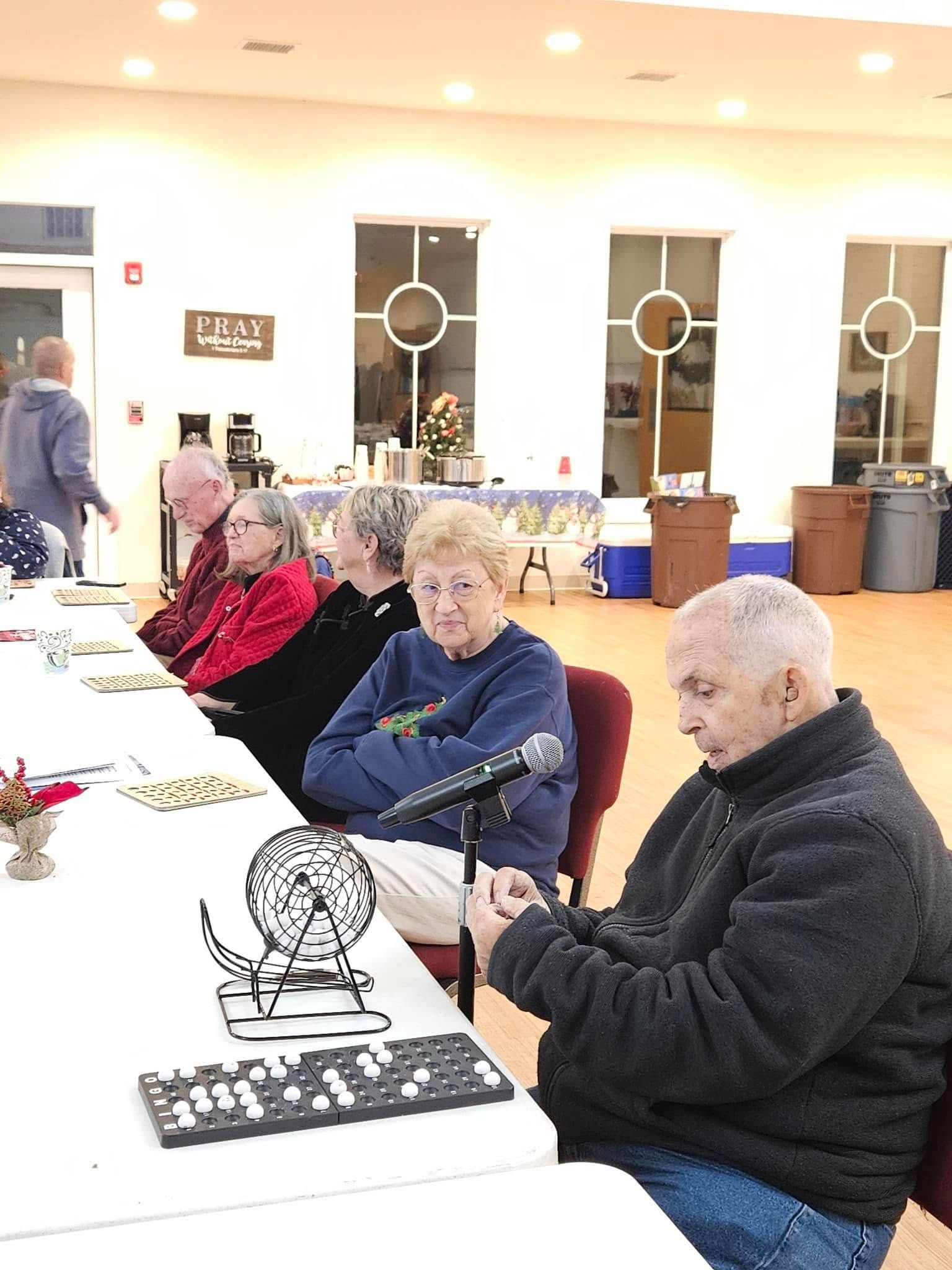 A group of people are sitting at a table in a room.