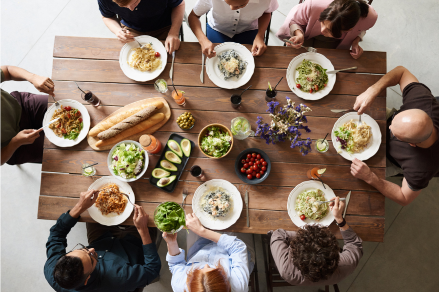 A group of people are sitting at a table eating food.