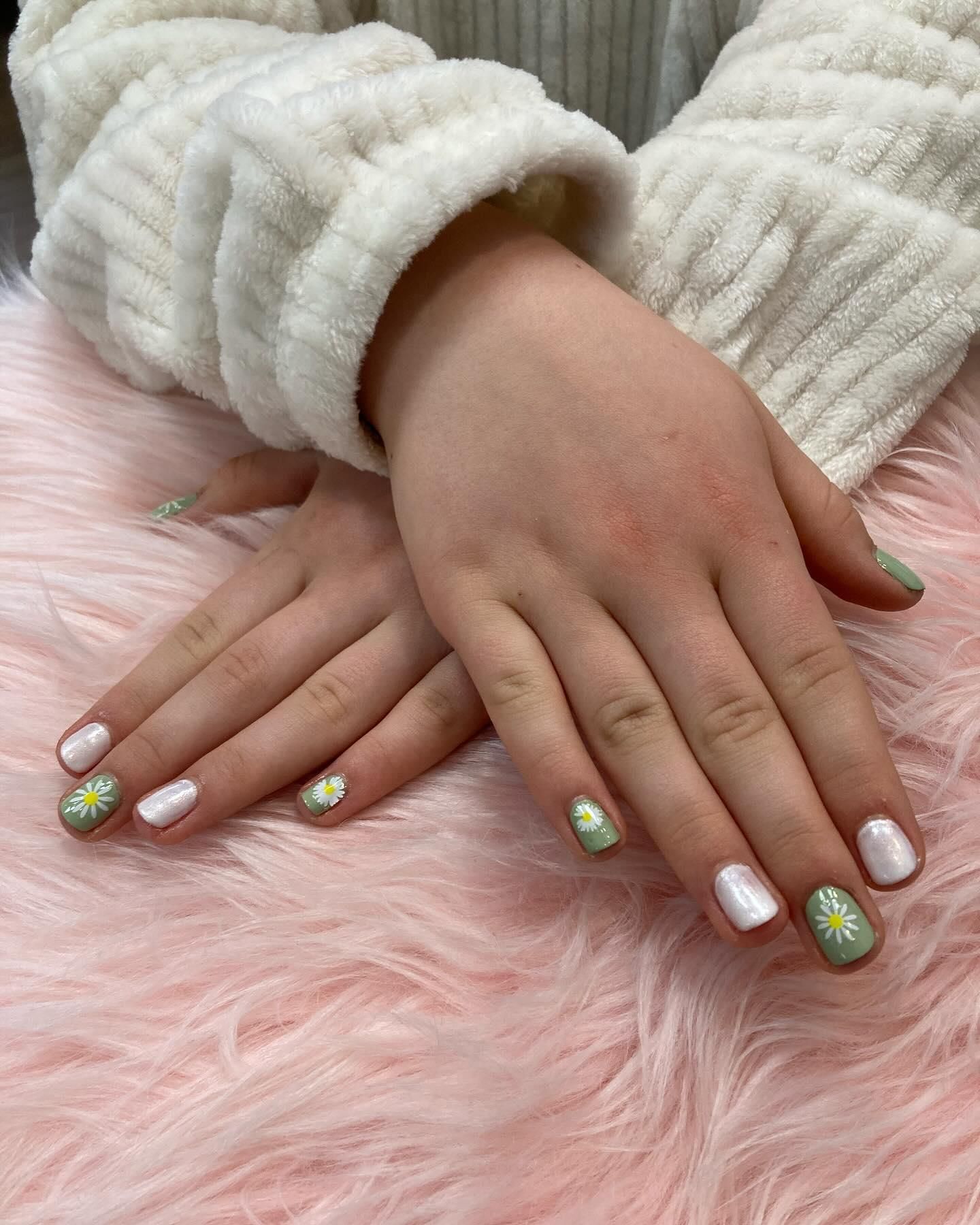Hands with short, painted nails; some with white polish.