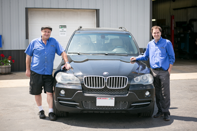 Two staff members in front of BMW car | Grahams Auto & Truck Clinic 