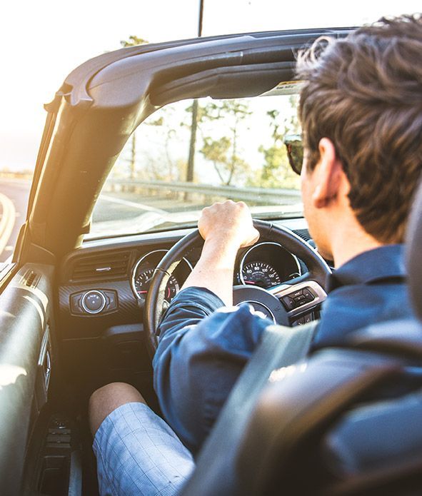 Man driving on the road, view from inside the car with roof down | Grahams Auto & Truck Clinic