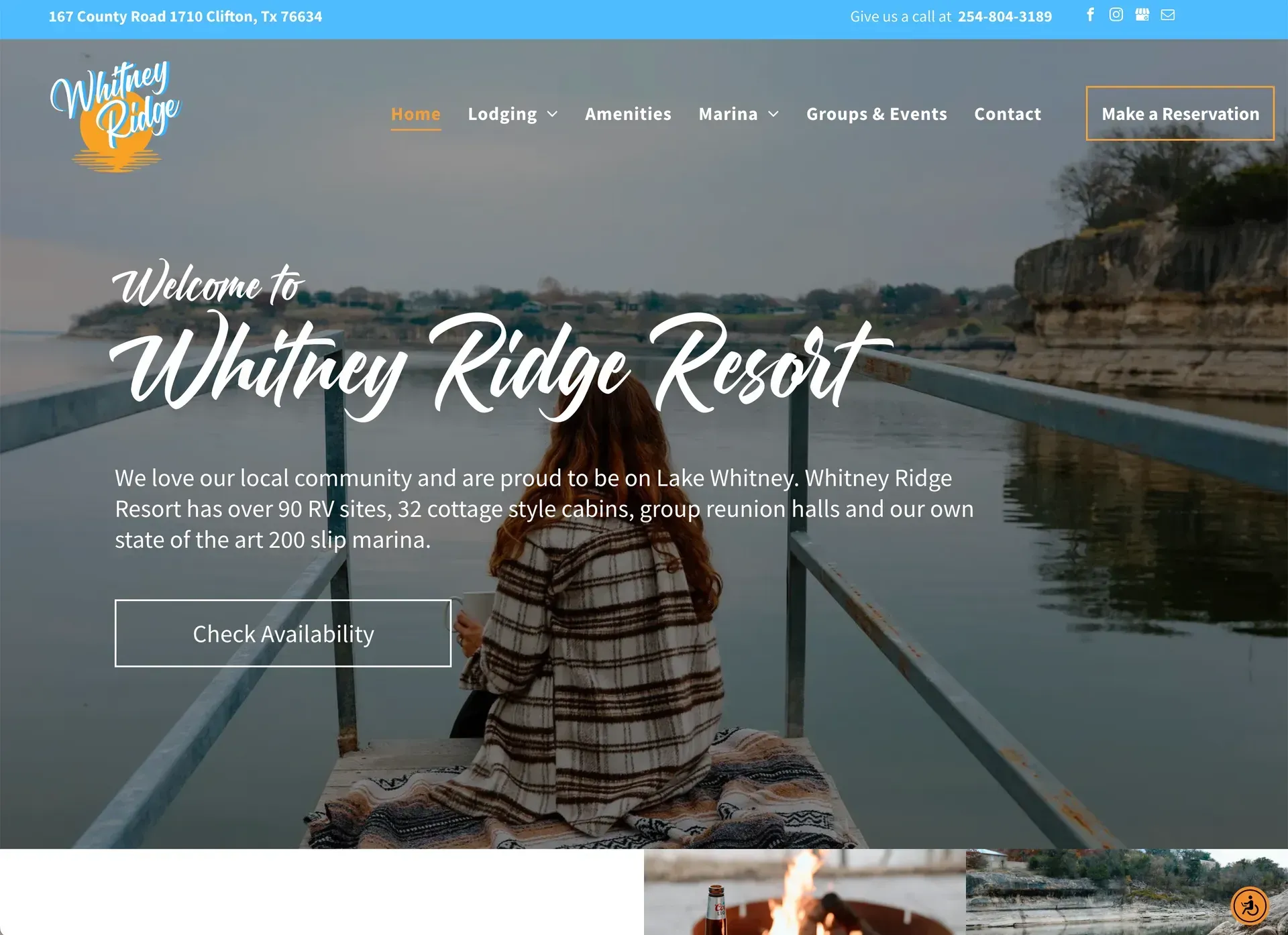 A woman is sitting on a dock overlooking a lake.