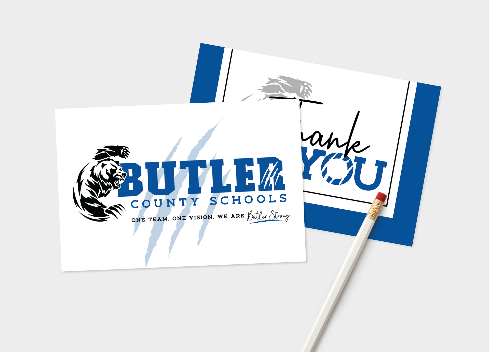 A pencil is sitting on top of a butler county schools thank you card.