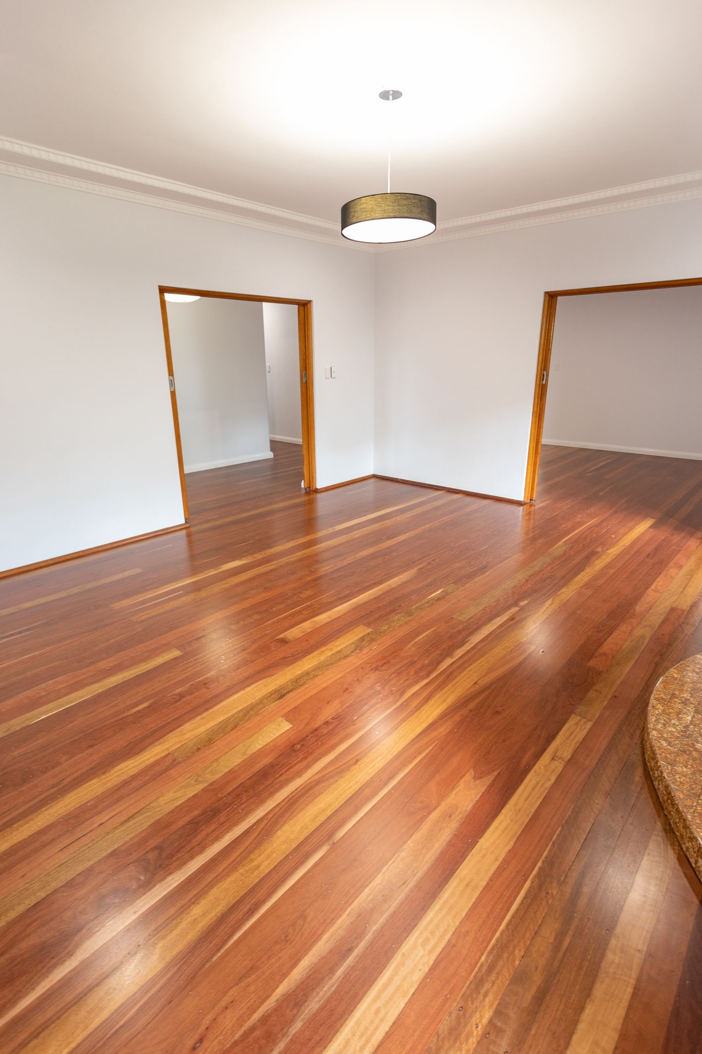 Newly renovated living room with polished wood floors.