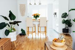 A living room with hardwood floors and a bowl of fruit on a table.