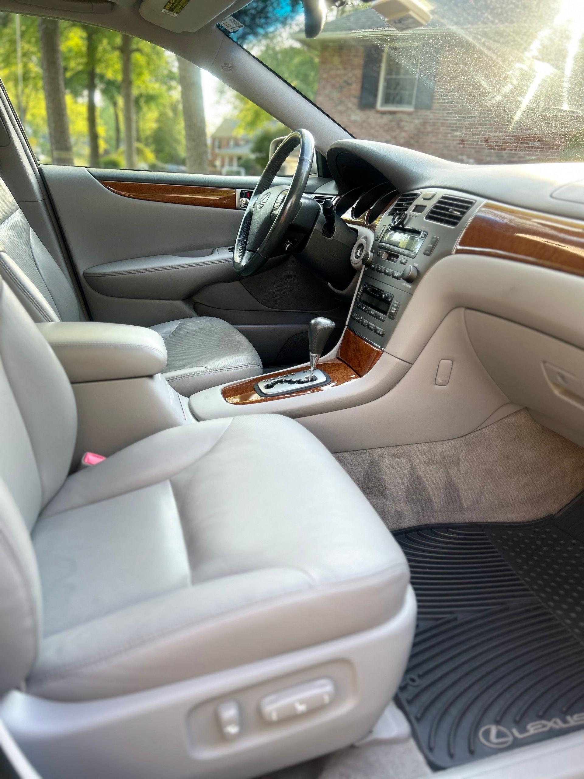 Driver’s seat and steering wheel after interior detail, featuring sanitized touchpoints and restored finishes.