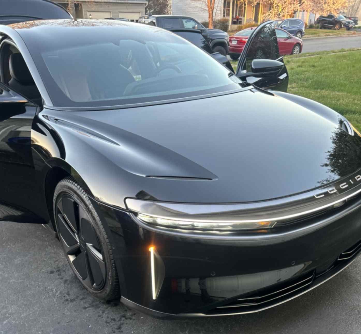 Lucid Air luxury EV in front three-quarter view with clean panels, sharp gloss, and spotless glass after premium detailing.