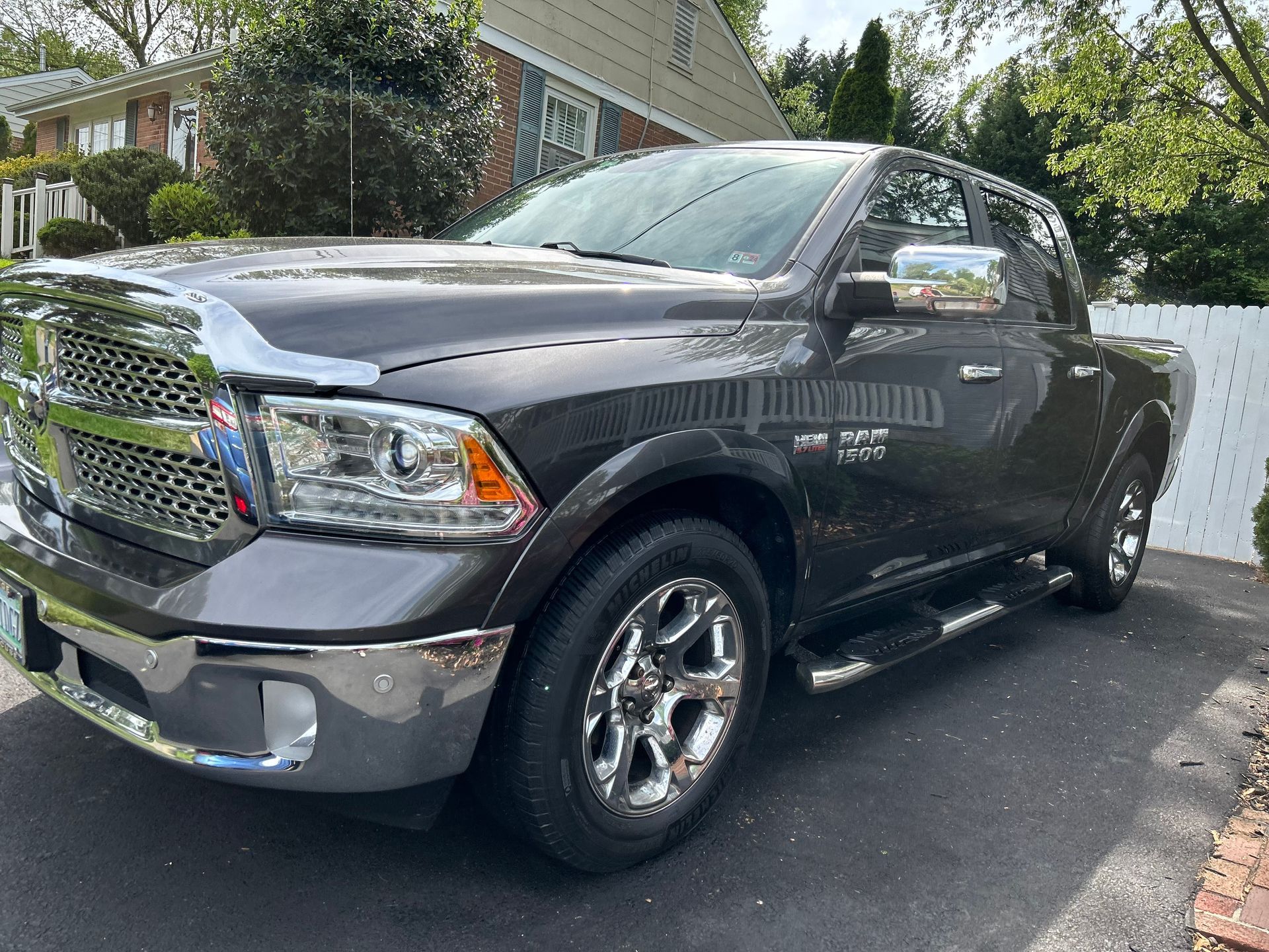 Gray Ram 1500 pickup truck with chrome grille and wheels, photographed after professional exterior truck detailing