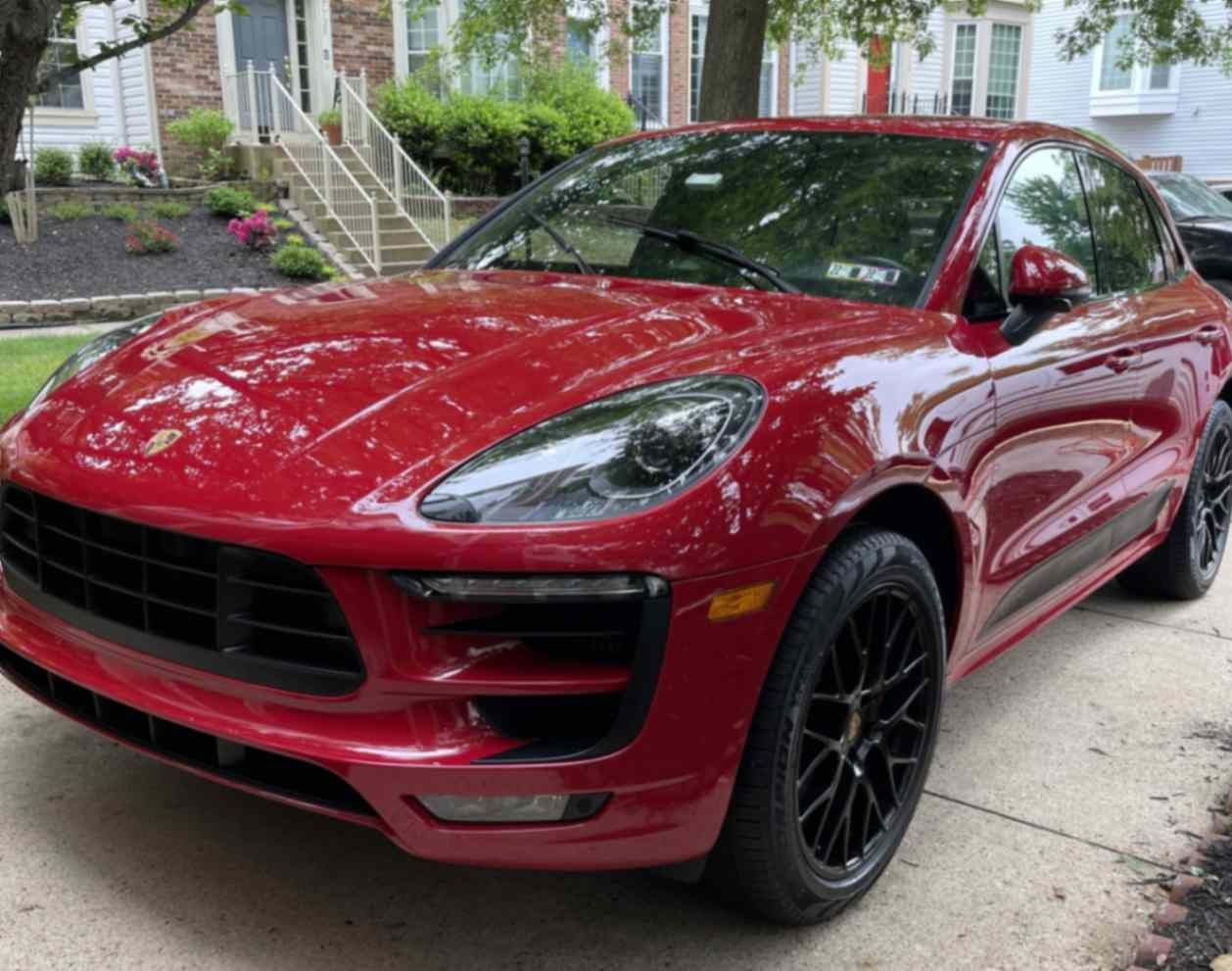 Red Porsche Macan GTS SUV with bright paint, clean wheels, and sharp details after thorough wash and durable protection.