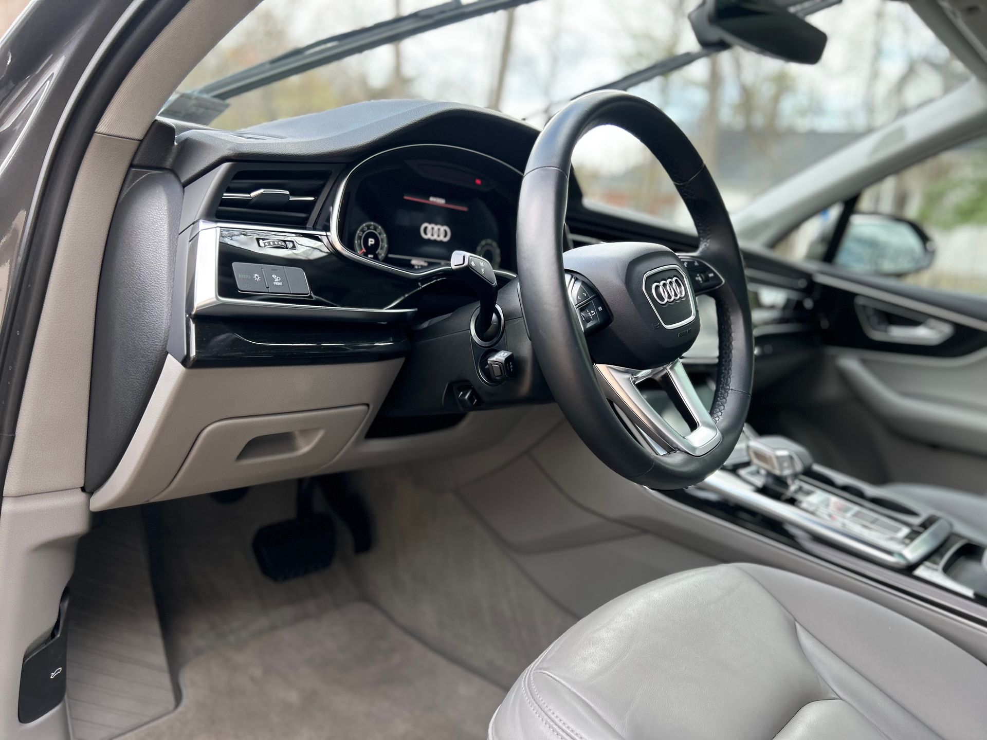 Compact car interior after detailing, highlighting clean fabric seats, treated plastics, and clear interior glass.