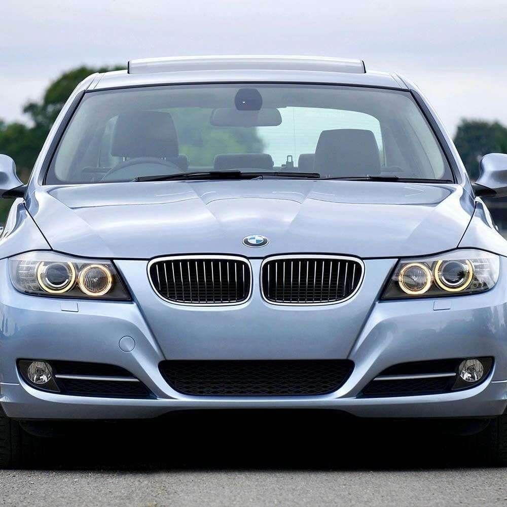 Silver BMW with polished windshield prepared after scratch treatment service.