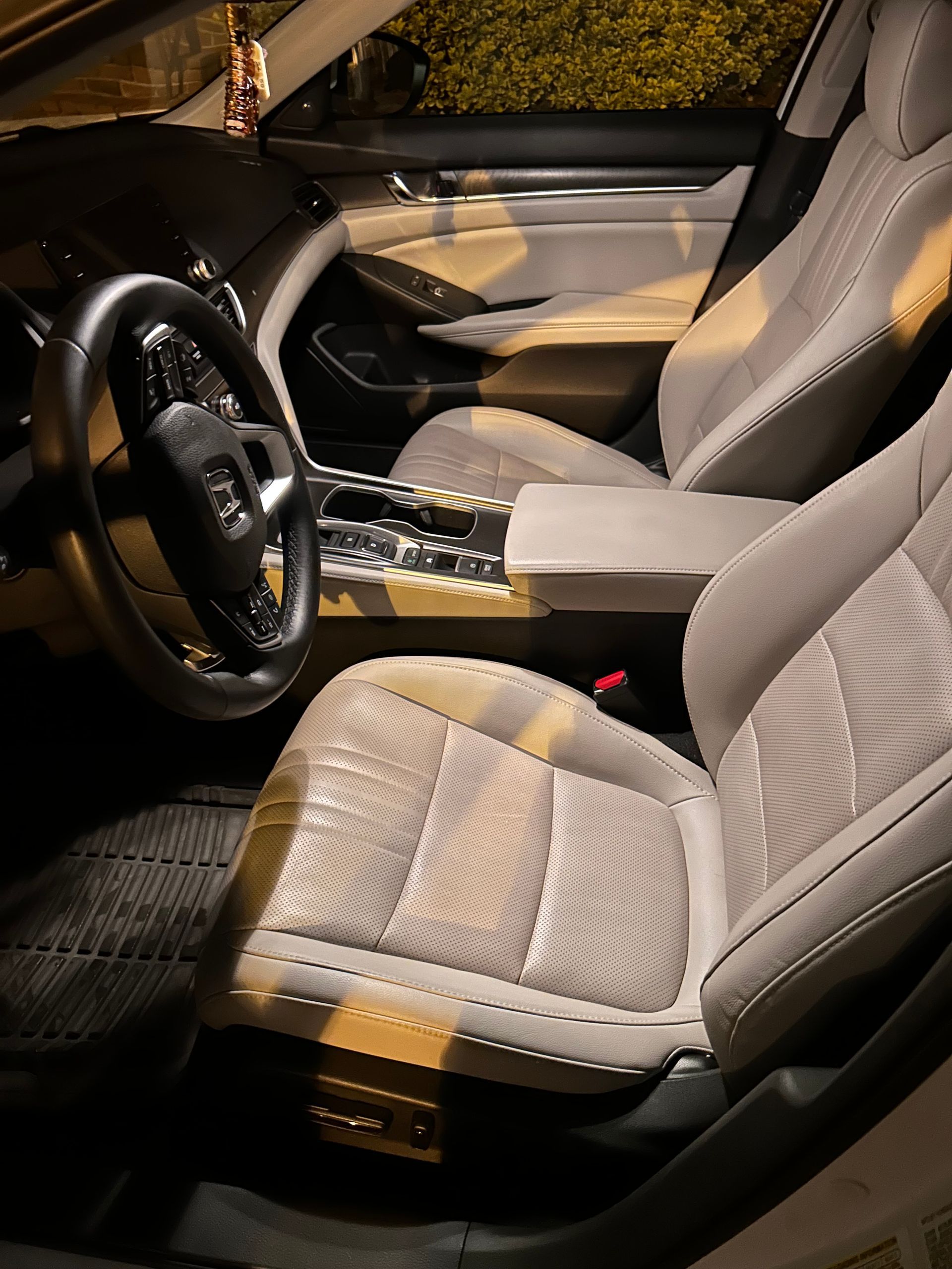 Luxury SUV interior after full detail, with clean leather seats, dust-free vents, and a streak-free touchscreen display.