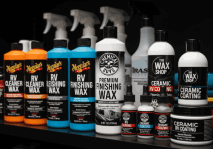 Collection of premium RV waxes, sealants, and ceramic coatings displayed on a shelf, showing detailing products used for RV protection.