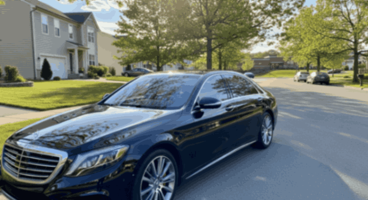 Black Mercedes-Benz sedan parked on suburban street in late fall, showcasing luxury design and seasonal detailing.