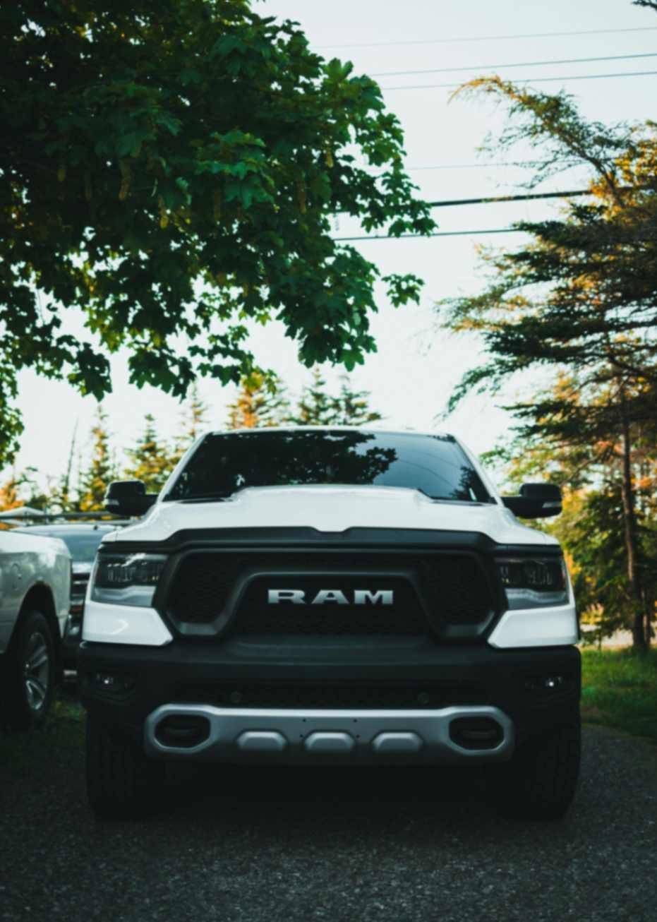 White Ram truck in shaded driveway prepped for exterior and trim detailing.