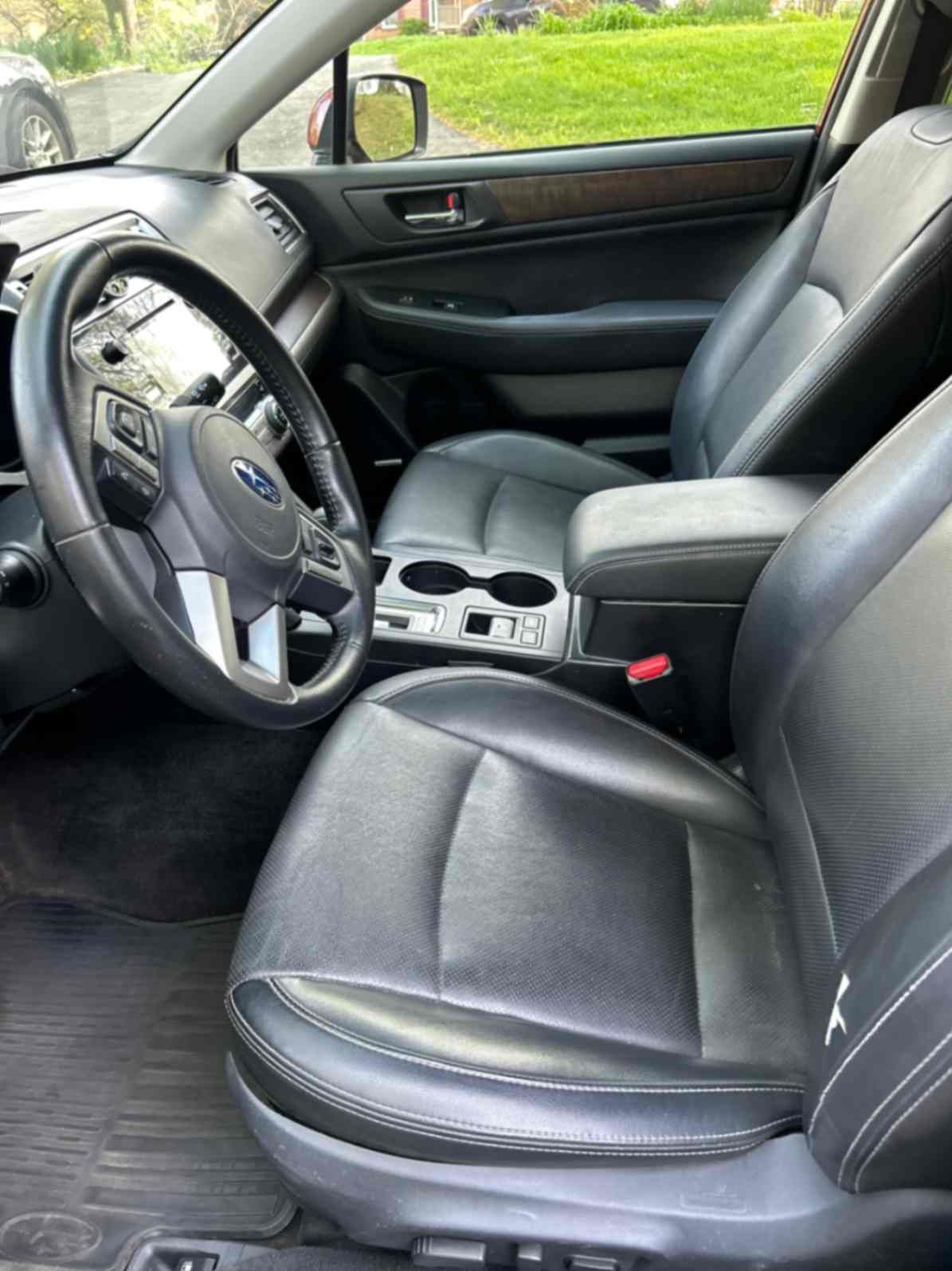Porsche Macan parked near a building, featuring sharp aerodynamic lines, black wheels.