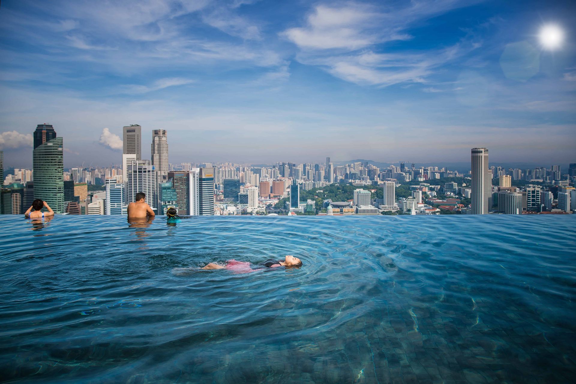 People swimming at a commercial infinity pool