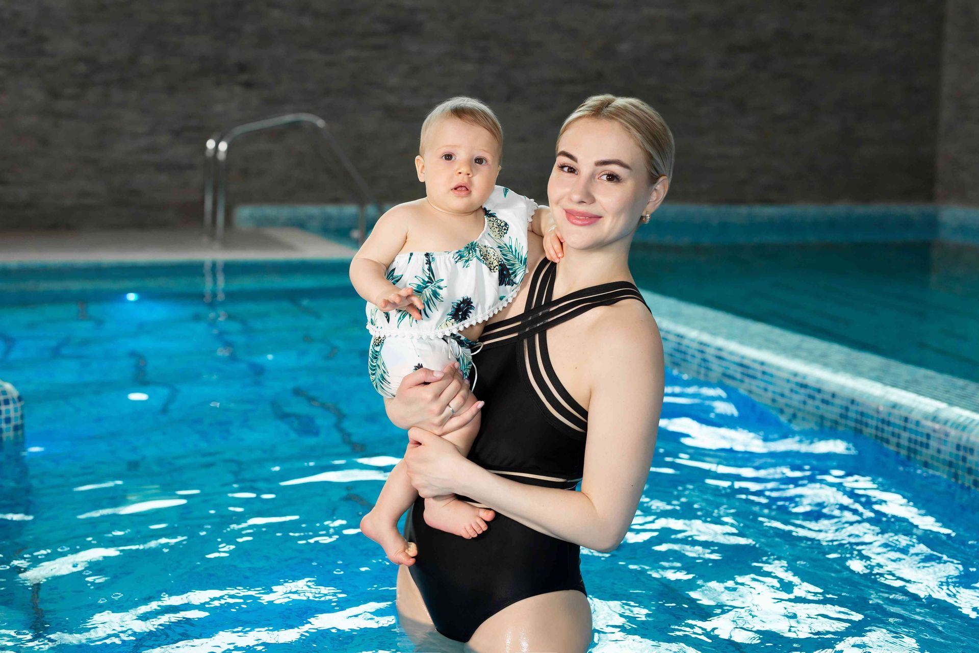 A woman and her child in their new swimming pool