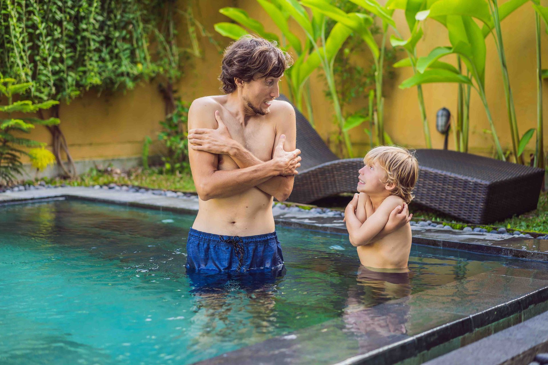 Father and son in a cold pool shivering