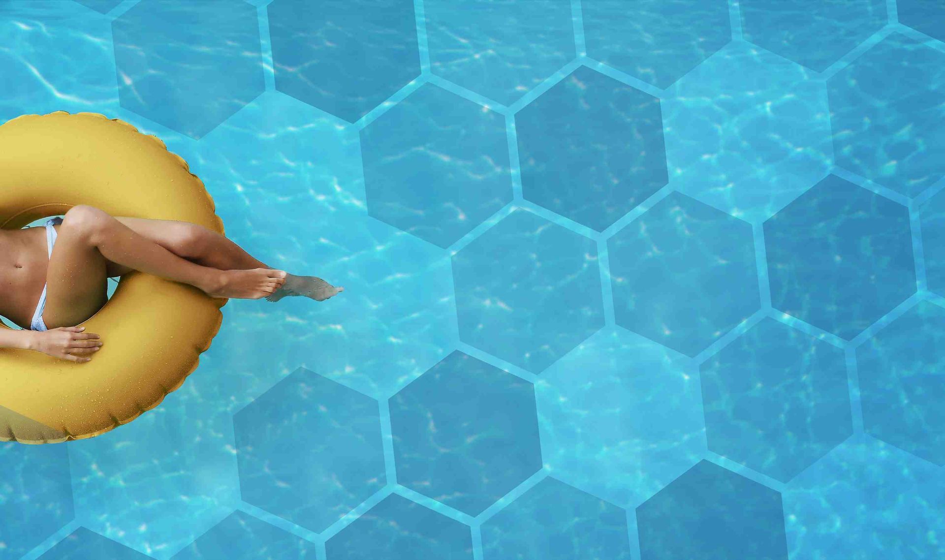 A woman floating on an doughnut in a swimming pool