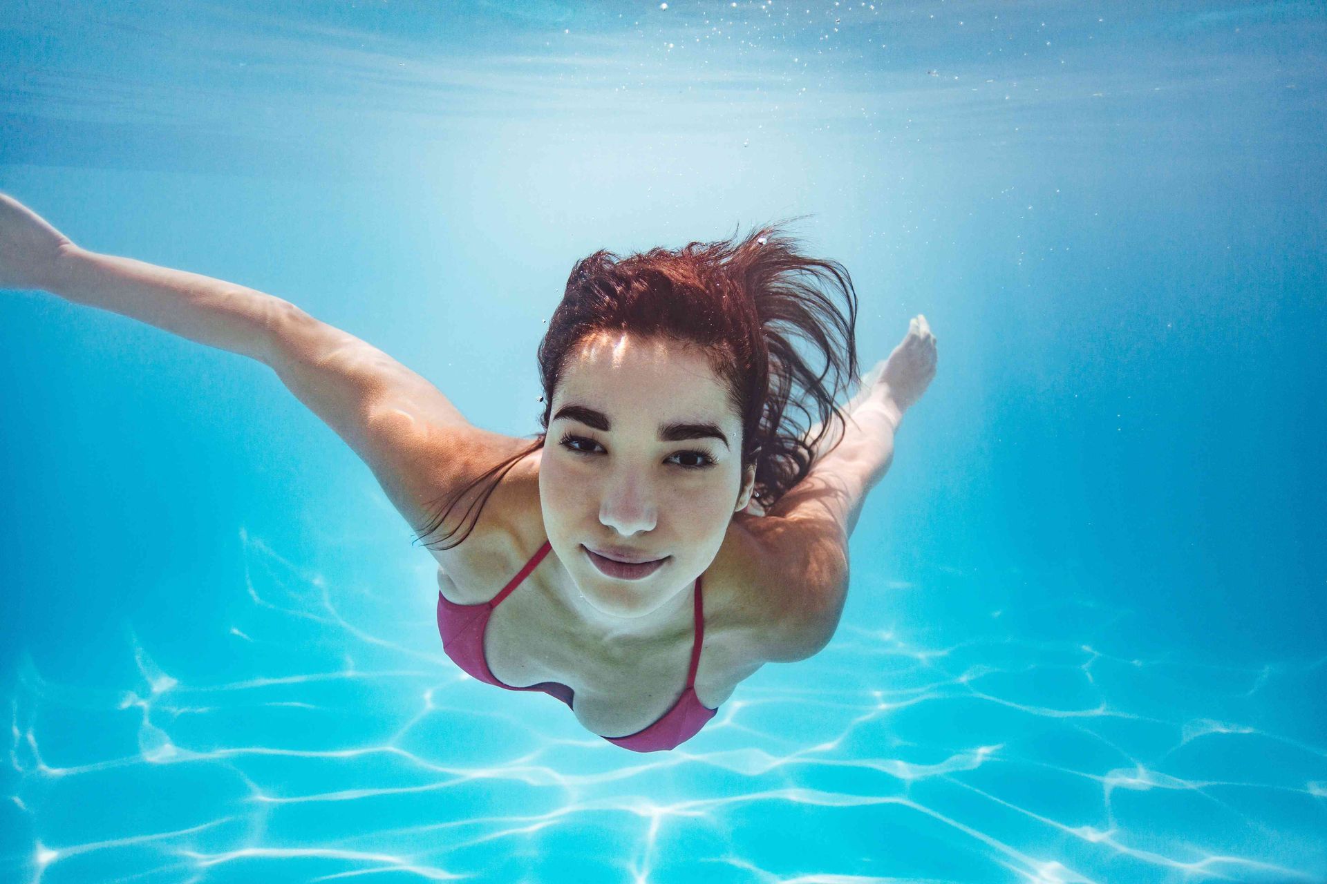 a pretty woman swimming under water