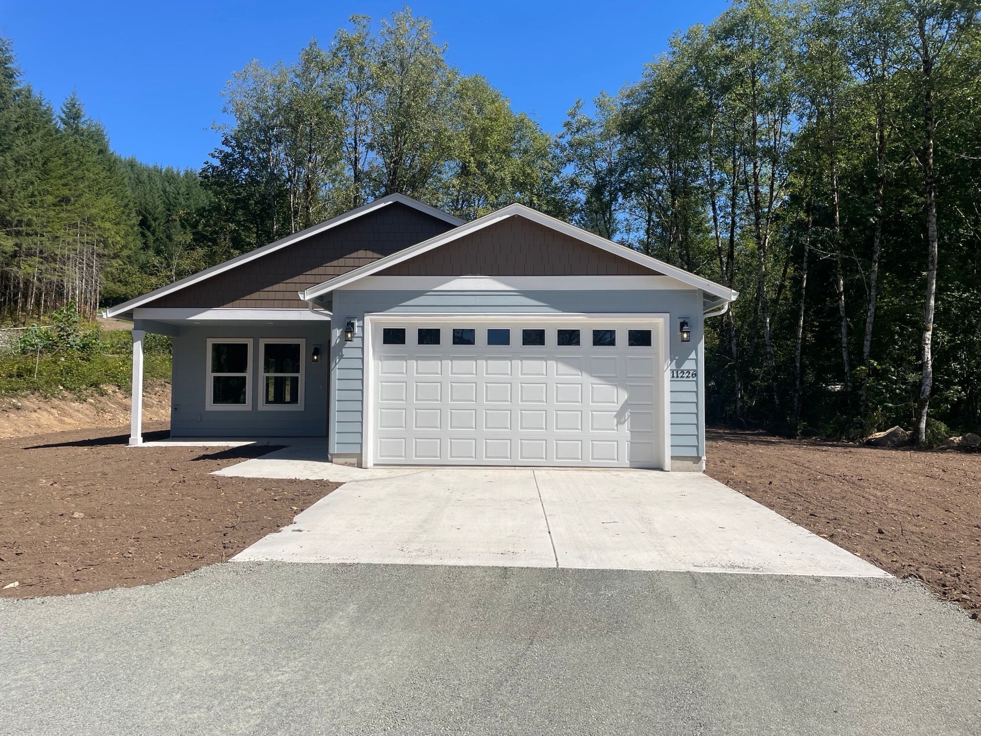 A house with a garage and a driveway in front of it
