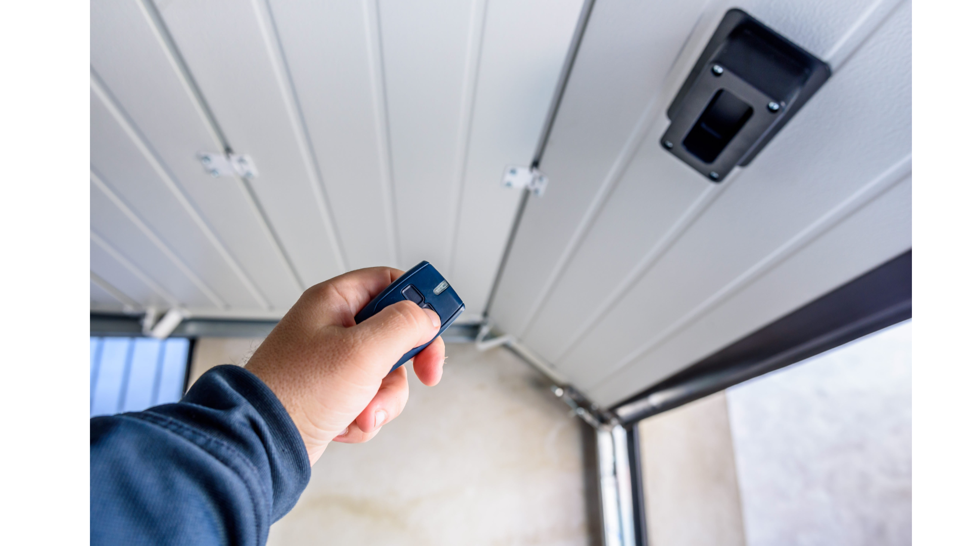 A person is using a remote control to open a garage door.