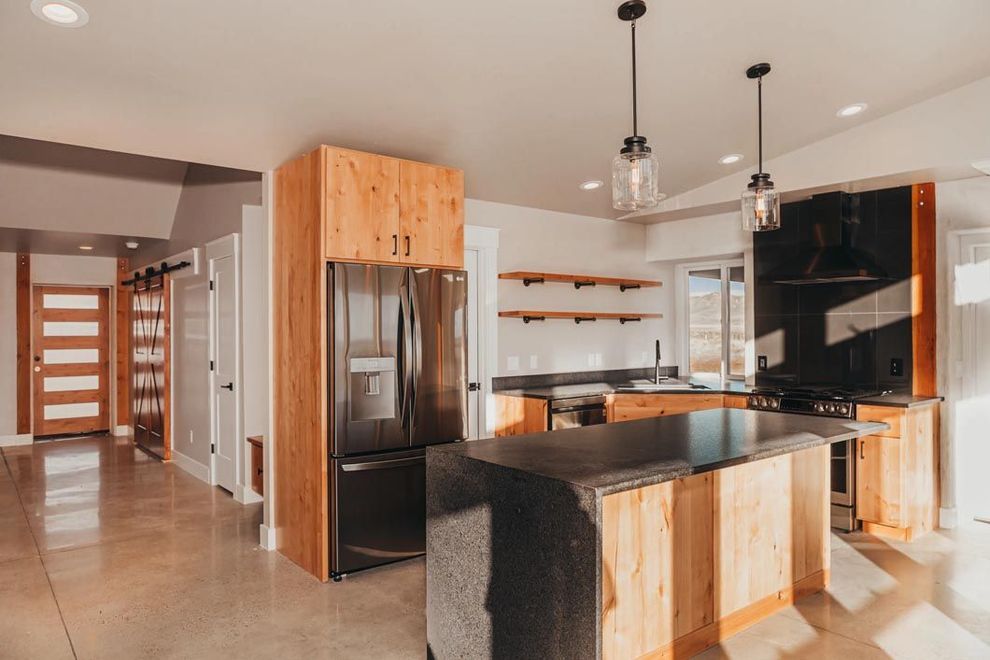 A kitchen with stainless steel appliances and wooden cabinets.