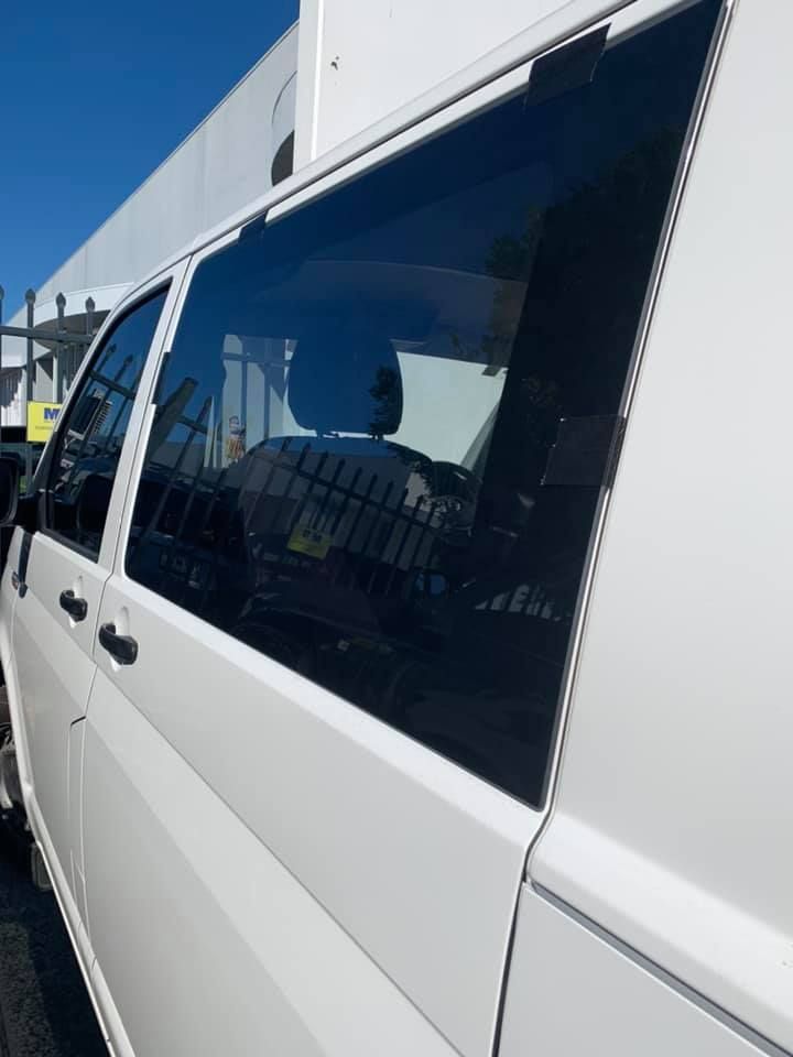 White Van With Tinted Windows Parked Outside on a Sunny Day — Motor Accessories Direct In Tweed Heads South, NSW