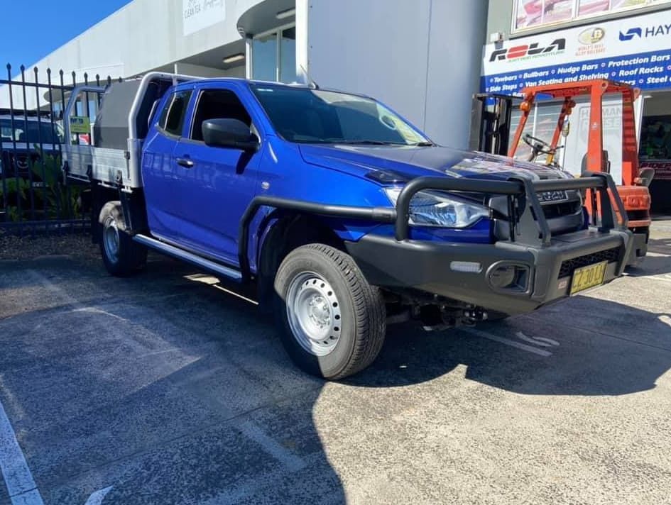 A Blue Truck Is Parked in A Parking Lot in Front of A Building — Motor Accessories Direct In Tweed Heads South, NSW