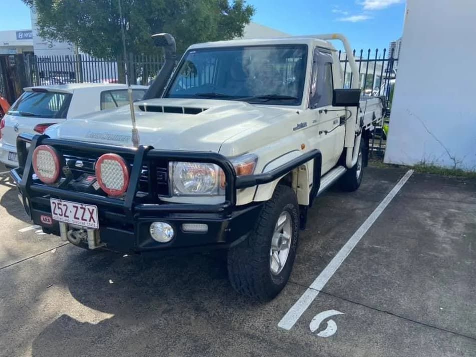 A White Truck Is Parked in A Parking Lot Next to A Building — Motor Accessories Direct In Tweed Heads South, NSW