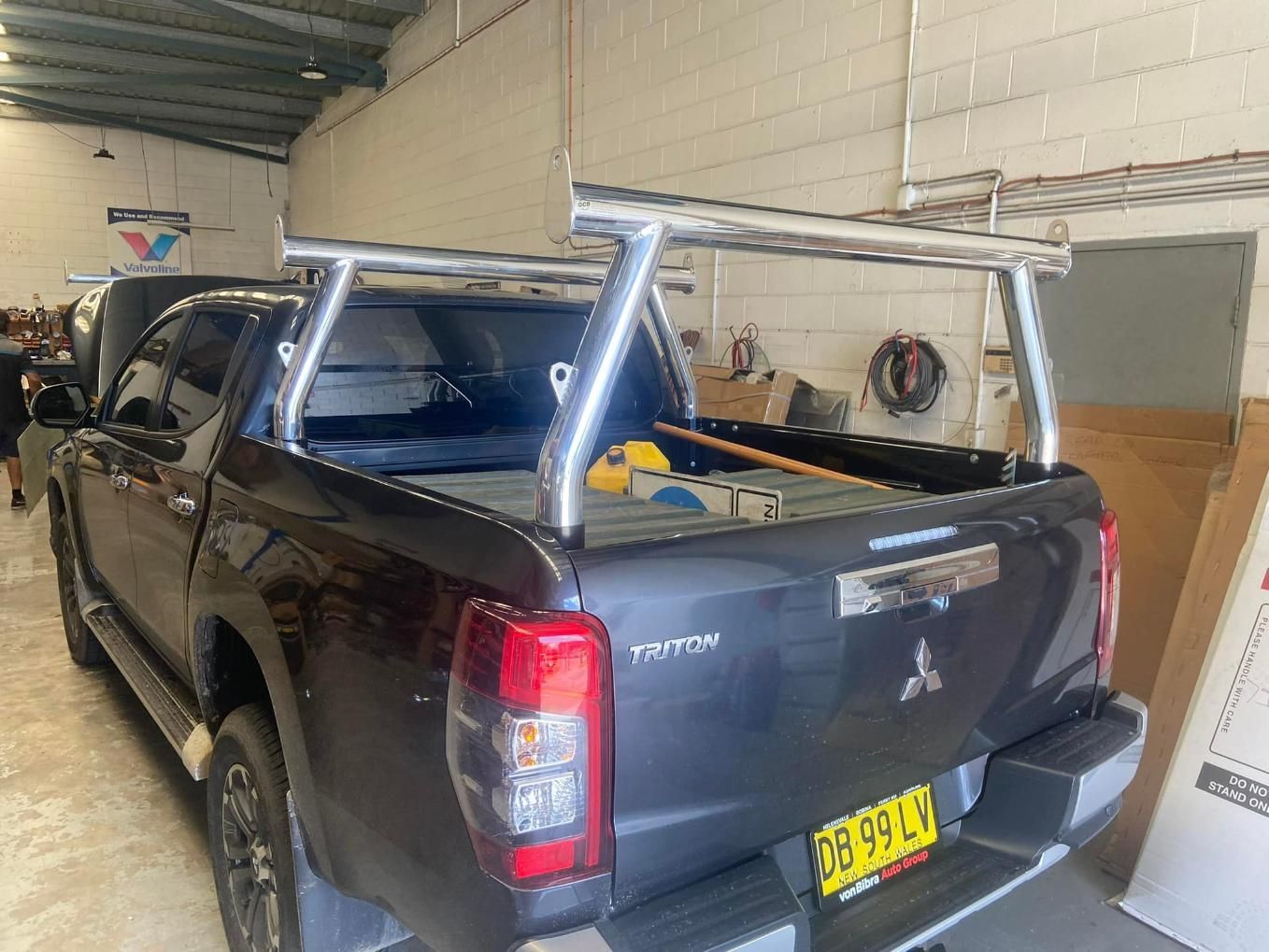 A Black Mitsubishi Triton Pickup Truck With a Silver Roof Rack — Motor Accessories Direct In Burleigh Heads, QLD