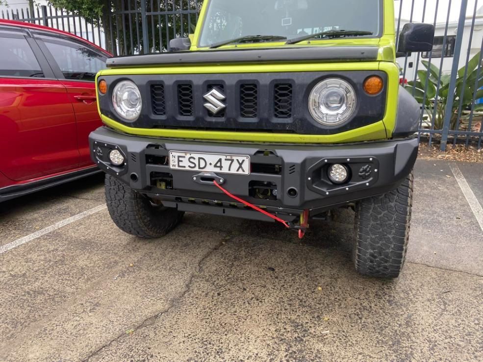 Yellow Suzuki Jimny With a Black Front Bumper Parked in a Lot — Motor Accessories Direct In Robina, QLD