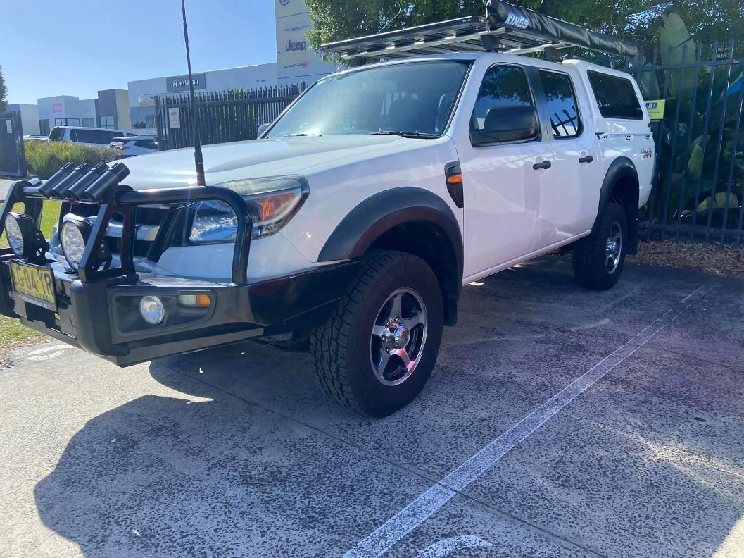 White Ford Ranger Truck With Bull Bar, Roof Rack, and Large Tires — Motor Accessories Direct In Burleigh Heads, QLD